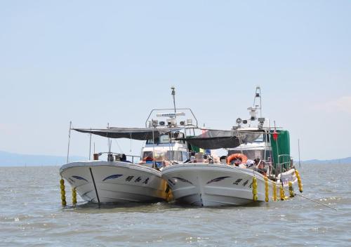 two boats in the water next to each other at APA Hotel Saga Ekimae Chuo in Saga
