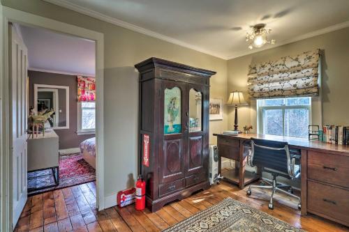 a home office with a desk and a wooden cabinet at Cozy Litchfield House with Fenced-In Yard and Fire Pit in Litchfield