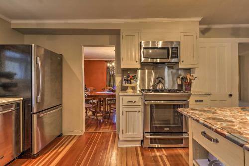 a kitchen with white cabinets and stainless steel appliances at Cozy Litchfield House with Fenced-In Yard and Fire Pit in Litchfield