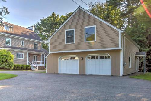 a house with a two car garage in a driveway at half Mi to Beach Lovely Guesthouse in Kennebunk! in Kennebunk