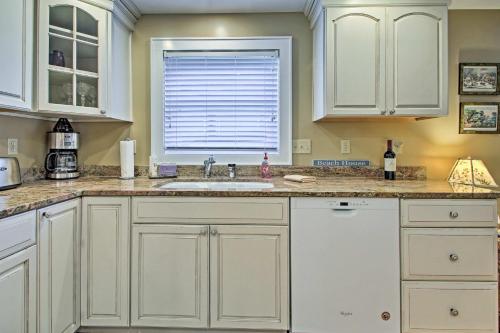 a kitchen with white cabinets and a sink and a window at half Mi to Beach Lovely Guesthouse in Kennebunk! in Kennebunk