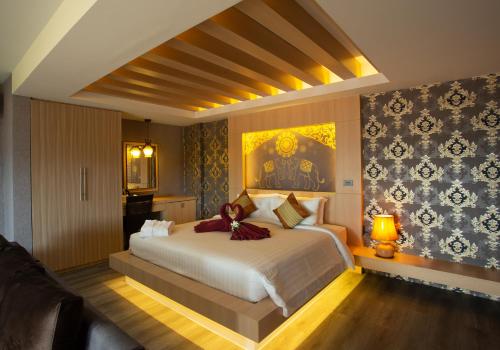 a bedroom with a large bed and a painting on the wall at Sita Beach Resort in Ko Lipe