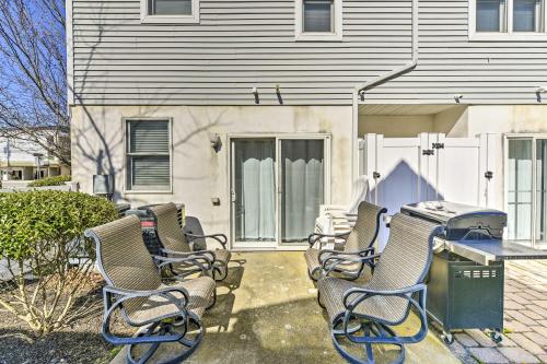 a group of chairs sitting outside of a house at Wildwood Townhome with Patio 1 Block To The Beach! in Wildwood