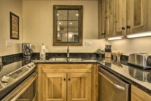 a kitchen with wooden cabinets and a sink and a window at Walkable Adobe-Style Abode with Community Amenities! in Santa Fe