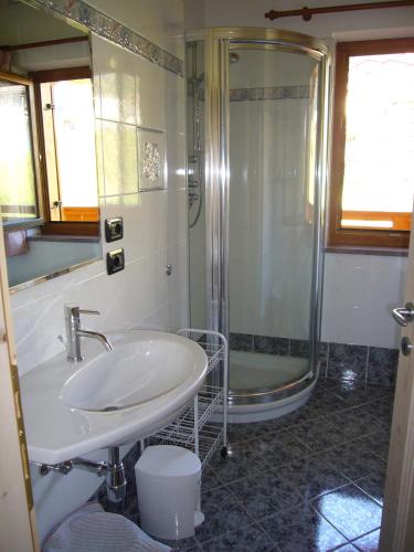 a bathroom with a sink and a shower at Casa Davarda in Vigo di Fassa