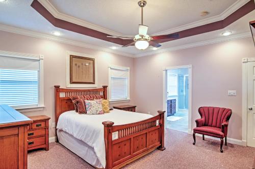 a bedroom with a bed and a desk and a chair at Waterfront Slidell Home with Boat Dock and Canal View! in Slidell