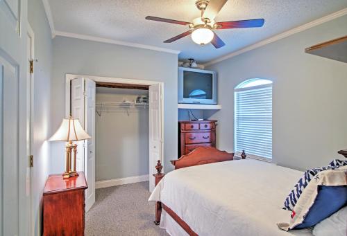 a bedroom with a bed and a ceiling fan at Waterfront Slidell Home with Boat Dock and Canal View! in Slidell