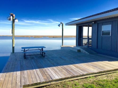 a bench sitting on a dock next to the water at Waterfront Slidell Home with Boat Dock and Canal View! in Slidell