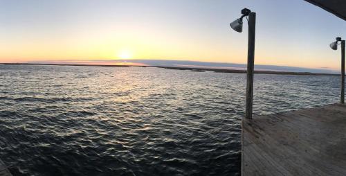 a view of the ocean at sunset from a boat at Waterfront Slidell Home with Boat Dock and Canal View! in Slidell