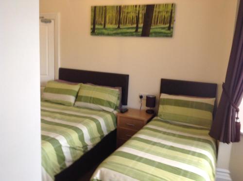 two beds sitting next to each other in a bedroom at Claydens in Cleethorpes