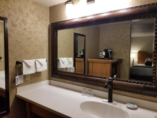 a bathroom with a sink and a large mirror at The Rockwell Inn in Jackson