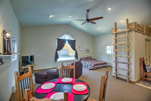 a living room with a table and a ceiling fan at Semi-Private Mancos Cabin on 80 Acres with Mtn View! in Dolores