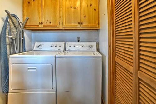 a kitchen with a white dishwasher and wooden cabinets at Dolores Home on 19 Acres with Scenic Mountain Views! in Dolores