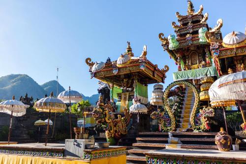 a group of buildings with umbrellas on top at Umma Bali Menjangan Retreat in Banyuwedang