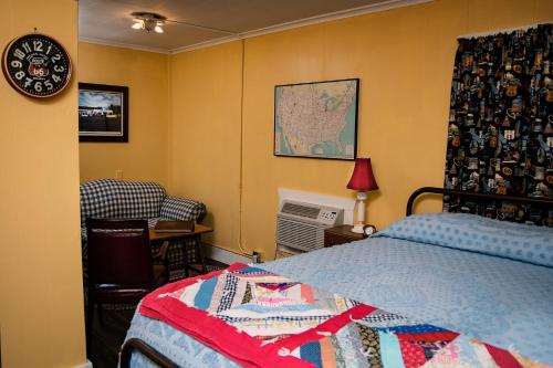 a bedroom with a bed and a map on the wall at Rockwood Motor Court in Springfield