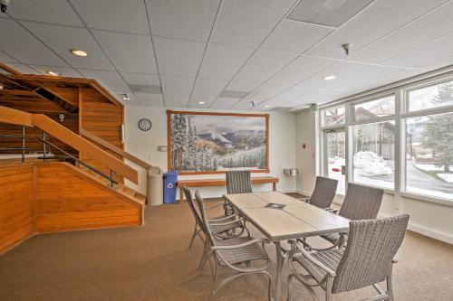 a dining room with a table and chairs and a staircase at Copper Mountain Condo Walk to American Eagle Lift in Copper Mountain