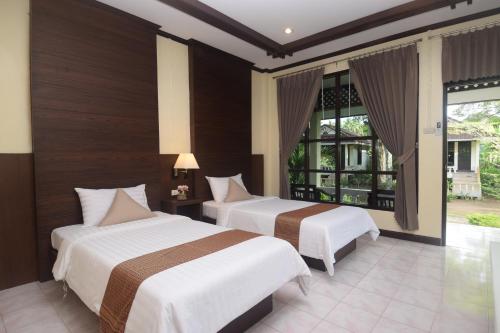 Ένα ή περισσότερα κρεβάτια σε δωμάτιο στο Clean Beach Resort