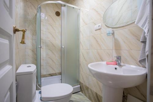 a bathroom with a sink and a toilet and a shower at Gantiadi in Kutaisi