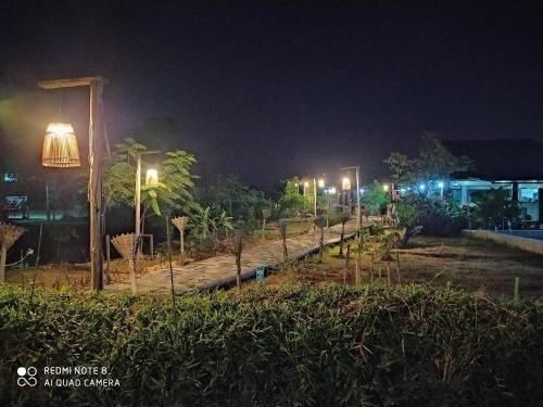 a row of lights on a street at night at Angels Chambres d'hotes in Rong Sak