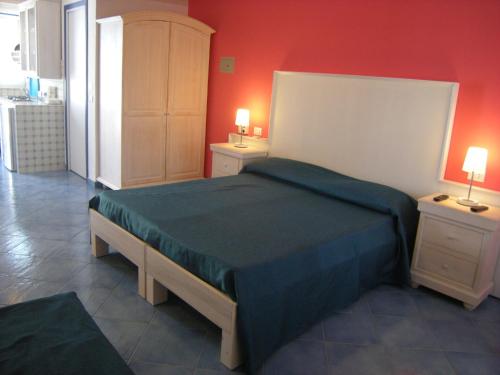 a bedroom with a bed and two night stands at Residence Timeo in Ustica