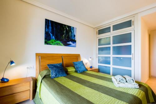 a bedroom with a bed and a large window at Apartamentos Balcon de Los Gigantes in Puerto de Santiago