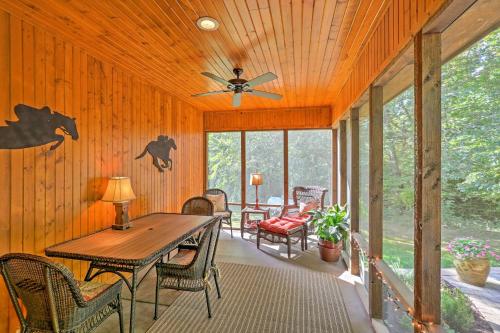 a screened in porch with a table and chairs at Beautiful Makanda Cabin in Shawnee National Forest in Makanda
