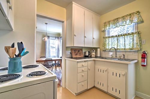 a kitchen with white cabinets and a stove top oven at Walk to Dtwn Bozeman Townhome with Fast WiFi in Bozeman
