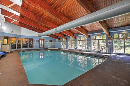 a large swimming pool in a building with wooden ceilings at Winter Park Condo with Hot Tubs, 4 Mi to Ski Resort! in Winter Park