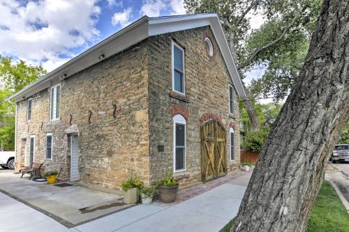 an old brick building with a large tree at Charming Historic Condo - Walk to Downtown and UW in Laramie
