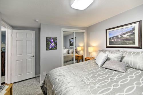 a bedroom with a bed with a white bedspread at Charming Historic Condo - Walk to Downtown and UW in Laramie