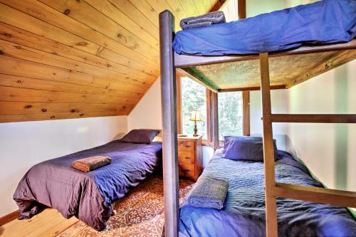 two bunk beds in a room with a wooden ceiling at East Burke House with Deck Less Than 3 Mi to Kingdom Trails! in East Burke