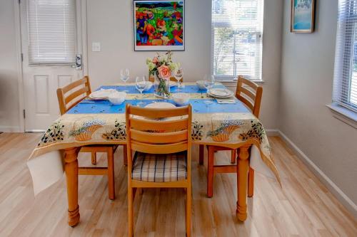 a dining room table with four chairs and a table cloth at Serene Bungalow-Style Home in Point Reyes Station! in Point Reyes Station