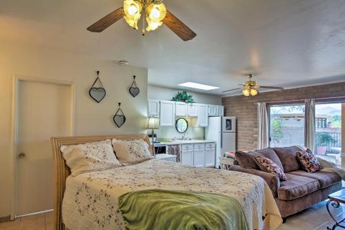 a bedroom with a bed and a couch at Tucson Casita with Fireplace View Animals and Mtns in Tucson