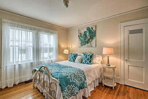 a bedroom with a bed with a blue blanket and a window at Central Wadesboro Home Walk to Downtown Shops! in Wadesboro