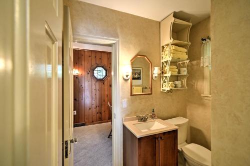 a bathroom with a sink and a toilet at Family-Friendly Fish Creek Cape House with Deck! in Fish Creek