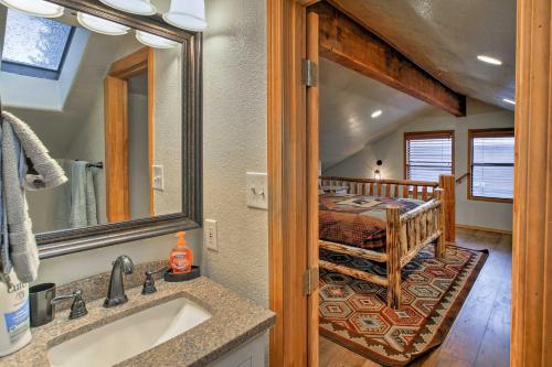 a bathroom with a sink and a bed in a room at Cabin on Rainbow Lake Views, Hot Tub and Dock in Pinetop-Lakeside