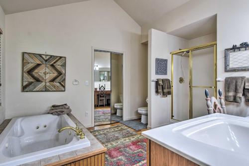 a white bathroom with a tub and a sink at High Gravity Banner Elk Custom Chalet with Views! in Banner Elk