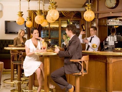 a bride and groom sitting at a bar at Naturresort Tannenhof GmbH in Großmaischeid