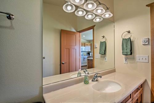 a bathroom with a sink and a large mirror at Sequim Cottage with Panoramic Olympic Mtn Views! in Sequim