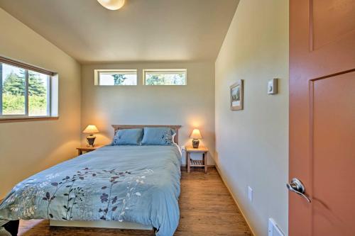 a bedroom with a bed and two windows at Sequim Cottage with Panoramic Olympic Mtn Views! in Sequim