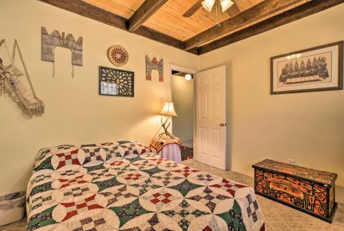 a bedroom with a bed with a quilt on it at Jemez Springs Cabin with Mtn Views Steps to River! in Jemez Springs