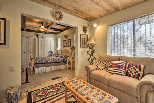 a living room with a couch and a bed at Unique Cabin with Mtn Views-Steps to the Jemez River! in Jemez Springs