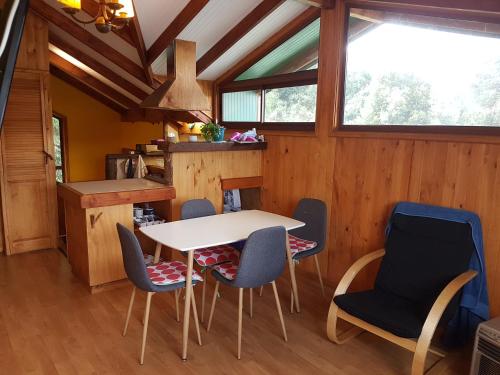 a dining room with a table and chairs at La Rueda del Chucao in Valdivia