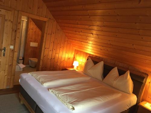 a bedroom with a bed in a wooden room at Gerstbreinhof in Bad Sankt Leonhard im Lavanttal