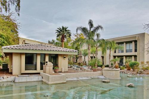 a house with a swimming pool in front of a house at Walk to Fashion Park! Phoenix Abode with Pool Access in Phoenix