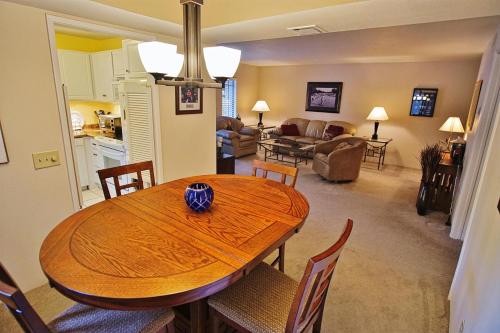 a dining room and living room with a wooden table at Walk to Fashion Park! Phoenix Abode with Pool Access in Phoenix