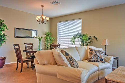 a living room with a couch and a table at North Phoenix Home with Pool Hike, Swim and Shop! in Anthem