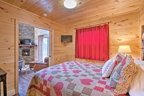 a bedroom with a bed and a red window in a cabin at Hot Tub and Views Charming Bryson City Cabin! in Bryson City