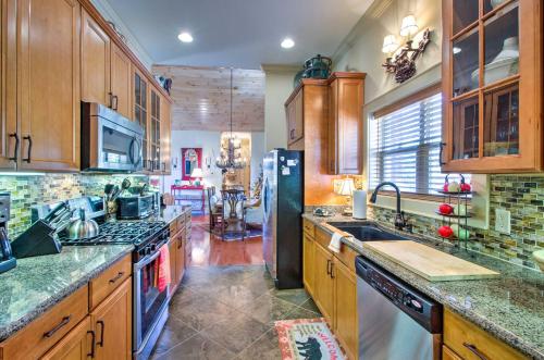 a kitchen with wooden cabinets and a black refrigerator at Bryson City Condo with Spectacular Views and Amenities in Whittier