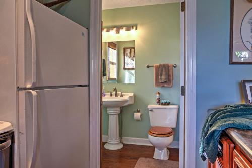 a bathroom with a refrigerator and a toilet and a sink at Paradise Cove Cabin with Boathouse and Dock in Guntersville